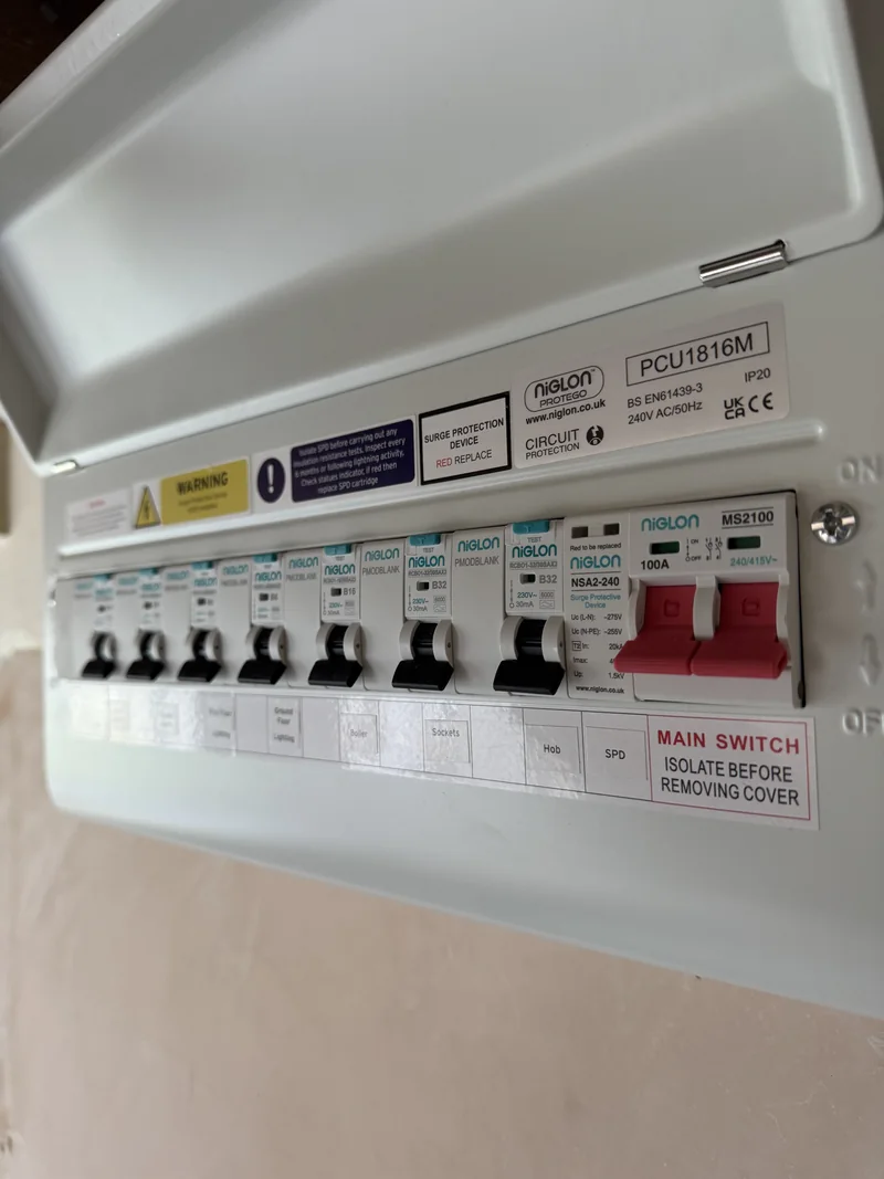 Close-up of Type 2 surge protection and RCBOs inside a Niglon consumer unit in Rushden