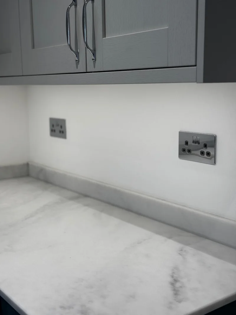 Polished chrome kitchen sockets installed above a finished worktop in Northampton