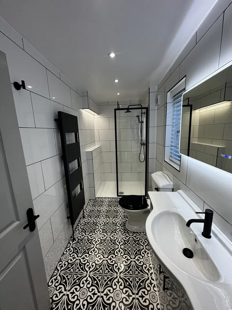 Luxury bathroom lighting installation in Kettering with LED downlights and illuminated mirror