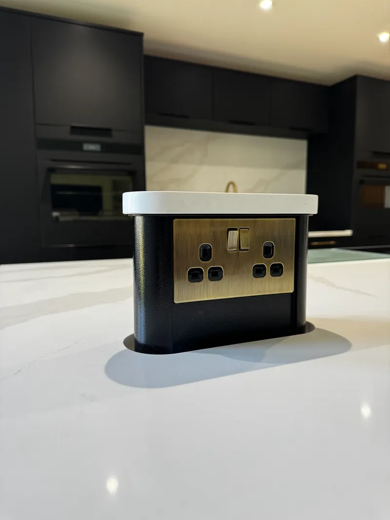 Motorised pop-up socket installed flush into a quartz kitchen island by Entigen — Burton Latimer