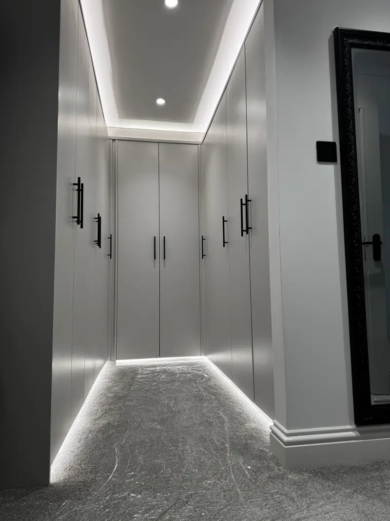 LED strip lighting and recessed spotlights in a luxury walk-in wardrobe